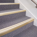 Satin Gold double insert chevron stair nosing, 70mm riser with White inserts, fitted on carpeted stairs