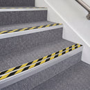 Satin Silver double insert chevron stair nosing, 70mm riser with Hazard black and yellow inserts, fitted on carpeted stairs