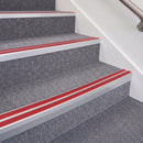 Satin Silver double insert chevron stair nosing, 70mm riser with Red inserts, fitted on carpeted stairs
