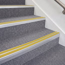 Satin Silver double insert chevron stair nosing, 70mm riser with Yellow inserts, fitted on carpeted stairs