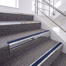 Bright Polished single insert chevron stair nosing, 65mm riser with Dark Blue insert, fitted on carpeted stairs