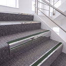 Bright Polished single insert chevron stair nosing, 65mm riser with Dark Green insert, fitted on carpeted stairs