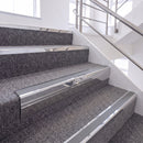Bright Polished single insert chevron stair nosing, 65mm riser with Mid Grey insert, fitted on carpeted stairs