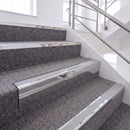 Bright Polished single insert chevron stair nosing, 65mm riser with Polar Grey insert, fitted on carpeted stairs