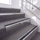 Bright Polished single insert chevron stair nosing, 65mm riser with Premium Black insert, fitted on carpeted stairs