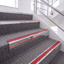 Bright Polished single insert chevron stair nosing, 65mm riser with Red insert, fitted on carpeted stairs