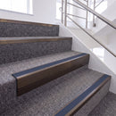 Dark Bronze single insert chevron stair nosing, 65mm riser with Blue insert, fitted on carpeted stairs