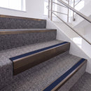 Dark Bronze single insert chevron stair nosing, 65mm riser with Dark Blue insert, fitted on carpeted stairs