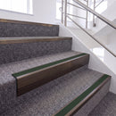 Dark Bronze single insert chevron stair nosing, 65mm riser with Dark Green insert, fitted on carpeted stairs