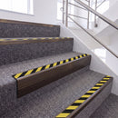 Dark Bronze single insert chevron stair nosing, 65mm riser with Hazard black and yellow insert, fitted on carpeted stairs