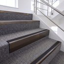 Dark Bronze single insert chevron stair nosing, 65mm riser with Premium Black insert, fitted on carpeted stairs