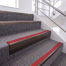 Dark Bronze single insert chevron stair nosing, 65mm riser with Red insert, fitted on carpeted stairs