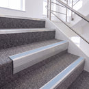 Mill Finish single insert chevron stair nosing, 65mm riser with Aura insert, fitted on carpeted stairs