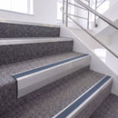 Mill Finish single insert chevron stair nosing, 65mm riser with Blue insert, fitted on carpeted stairs