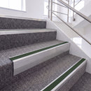 Mill Finish single insert chevron stair nosing, 65mm riser with Dark Green insert, fitted on carpeted stairs