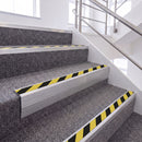 Mill Finish single insert chevron stair nosing, 65mm riser with Hazard black and yellow insert, fitted on carpeted stairs