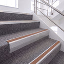 Mill Finish single insert chevron stair nosing, 65mm riser with Mid Brown insert, fitted on carpeted stairs