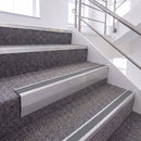 Mill Finish single insert chevron stair nosing, 65mm riser with Mid Grey insert, fitted on carpeted stairs