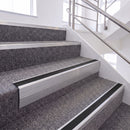 Mill Finish single insert chevron stair nosing, 65mm riser with Premium Black insert, fitted on carpeted stairs