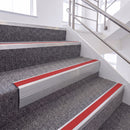 Mill Finish single insert chevron stair nosing, 65mm riser with Red insert, fitted on carpeted stairs
