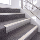 Mill Finish single insert chevron stair nosing, 65mm riser with White insert, fitted on carpeted stairs