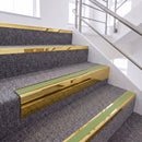 Mirrorflect Gold single insert chevron stair nosing, 65mm riser with Apple Green insert, fitted on carpeted stairs