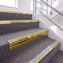 Mirrorflect Gold single insert chevron stair nosing, 65mm riser with Aura insert, fitted on carpeted stairs