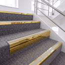 Mirrorflect Gold single insert chevron stair nosing, 65mm riser with Oyster insert, fitted on carpeted stairs