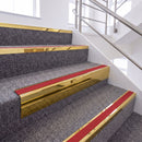 Mirrorflect Gold single insert chevron stair nosing, 65mm riser with Red insert, fitted on carpeted stairs