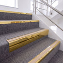 Mirrorflect Gold single insert chevron stair nosing, 65mm riser with Sahara insert, fitted on carpeted stairs