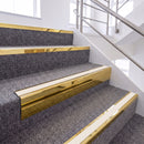 Mirrorflect Gold single insert chevron stair nosing, 65mm riser with White insert, fitted on carpeted stairs