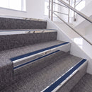 Mirrorflect Silver single insert chevron stair nosing, 65mm riser with Dark Blue insert, fitted on carpeted stairs