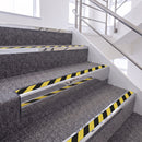Mirrorflect Silver single insert chevron stair nosing, 65mm riser with Hazard black and yellow insert, fitted on carpeted stairs