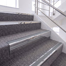 Mirrorflect Silver single insert chevron stair nosing, 65mm riser with Mid Grey insert, fitted on carpeted stairs