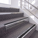 Mirrorflect Silver single insert chevron stair nosing, 65mm riser with Premium Black insert, fitted on carpeted stairs