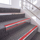Mirrorflect Silver single insert chevron stair nosing, 65mm riser with Red insert, fitted on carpeted stairs