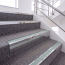 Mirrorflect Silver single insert chevron stair nosing, 65mm riser with Sage Green insert, fitted on carpeted stairs