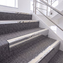 Mirrorflect Silver single insert chevron stair nosing, 65mm riser with White insert, fitted on carpeted stairs