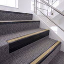 Satin Black single insert chevron stair nosing, 65mm riser with Beige insert, fitted on carpeted stairs