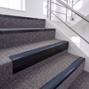 Satin Black single insert chevron stair nosing, 65mm riser with Blue insert, fitted on carpeted stairs