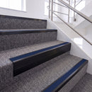 Satin Black single insert chevron stair nosing, 65mm riser with Dark Blue insert, fitted on carpeted stairs
