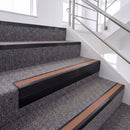Satin Black single insert chevron stair nosing, 65mm riser with Mid Brown insert, fitted on carpeted stairs