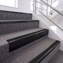Satin Black single insert chevron stair nosing, 65mm riser with Premium Black insert, fitted on carpeted stairs