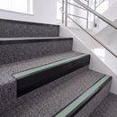 Satin Black single insert chevron stair nosing, 65mm riser with Sage Green insert, fitted on carpeted stairs