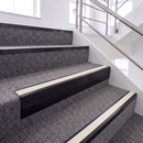 Satin Black single insert chevron stair nosing, 65mm riser with White insert, fitted on carpeted stairs