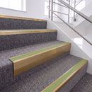 Satin Bronze single insert chevron stair nosing, 65mm riser with Apple Green insert, fitted on carpeted stairs