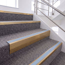 Satin Bronze single insert chevron stair nosing, 65mm riser with Aura insert, fitted on carpeted stairs
