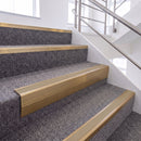 Satin Bronze single insert chevron stair nosing, 65mm riser with Beige insert, fitted on carpeted stairs