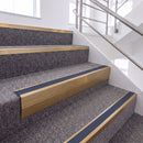 Satin Bronze single insert chevron stair nosing, 65mm riser with Blue insert, fitted on carpeted stairs