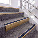 Satin Bronze single insert chevron stair nosing, 65mm riser with Dark Blue insert, fitted on carpeted stairs